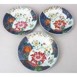 THREE 18TH CENTURY CHINESE FAMILLE ROSE PORCELAIN PLATES, decorated with an array of colours