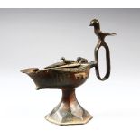 A BRONZE SELJUK LAMP, with bird shaped handle and finial, 15cm high.