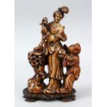 A 19TH / 20TH CENTURY CHINESE CARVED SOAPSTONE FIGURE OF GUANYIN & CHILD, the goddess stood