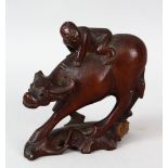 A 19TH CENTURY CHINESE CARVED CHERRYWOOD FIGURE OF AN OXEN & BOY, the boy riding upon the back of