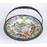A 19TH CENTURY CHINESE FAMILLE ROSE / VERTE PORCELAIN PLATE WITH METAL MOUNTS, the plate with staple