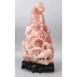 A LARGE 19TH CENTURY CHINESE ROSE QUARTZ VASE, COVER & STAND, the vase carved to depict scenes of