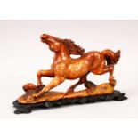 A 19TH / 20TH CENTURY CHINESE CARVED SOAPSTONE FIGURE OF A HORSE, the horse in a galloping pose