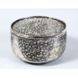 A 19TH CENTURY INDIAN PIERCED WHITE METAL CYLINDRICAL DISH & COVER, with pierced work depicting