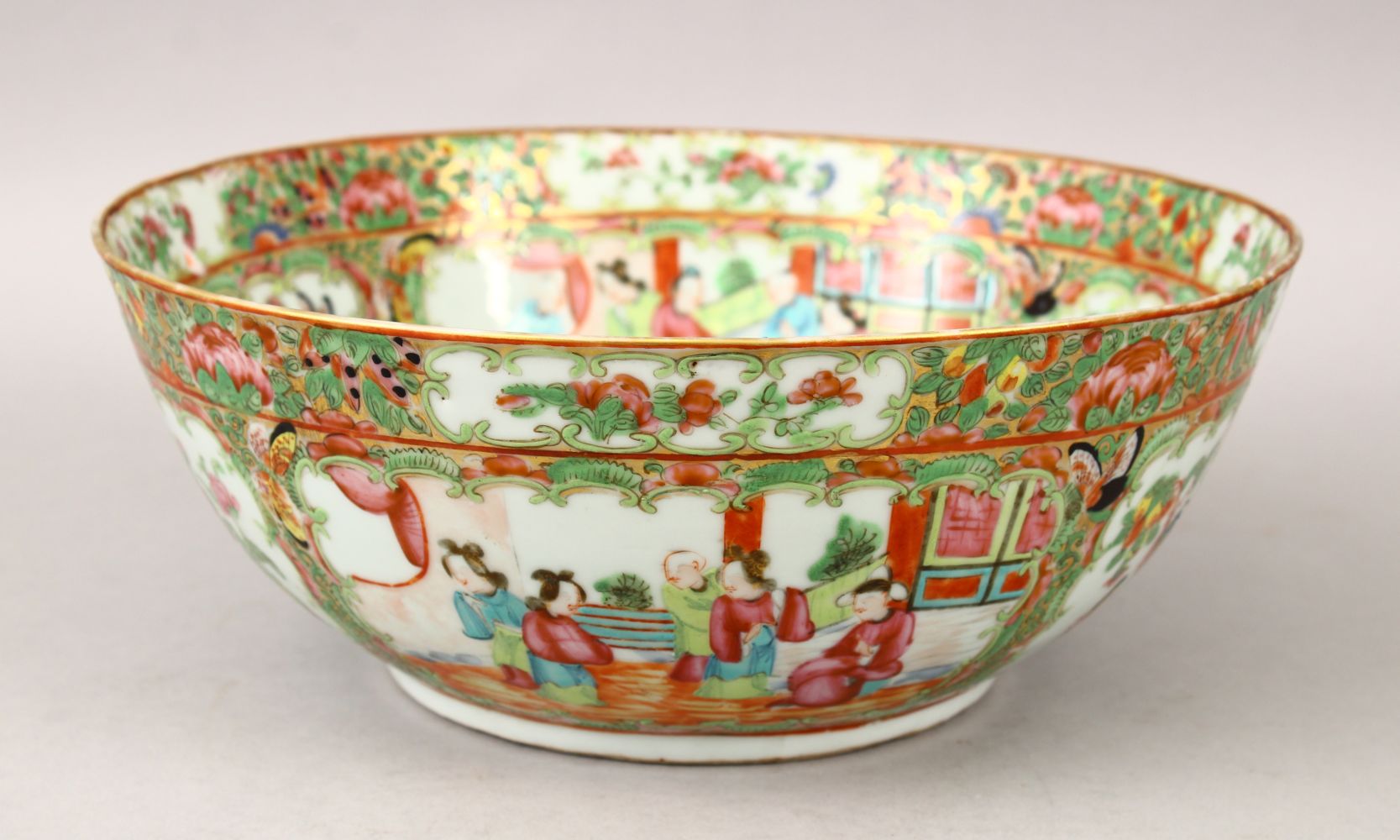 A 19TH CENTURY CHINESE CANTON FAMILLE ROSE PORCELAIN BOWL, decorated with panels of figures interior