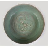 A CHINESE CELADON RU WARE DRAGON DISH, the interior with moulded decoration of an intertined dragon,