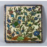 A 17TH / 18TH CENTURY ISLAMIC / IZNIK POTTERY TILE, decorated with floral style, 24cm square.