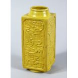 A CHINESE REPUBLIC PERIOD YELLOW GLAZED MOULDED CONG VASE, each section of the square form vase with