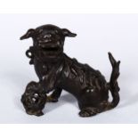 A GOOD EARLY CHINESE POSS MING BRONZE FIGURE OF KYLIN, in a seated position wwith his paw upon a