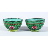 A PAIR OF 19TH / 20TH CENTURY CHINESE ENAMEL CUPS, decorated upon a green ground with formal