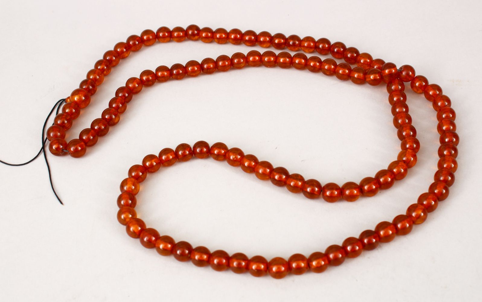 A LARGE 19TH CENTURY CHINESE AMBER ROSARY BEAD NECKLACE, comprising of 109 spherical beads, approx