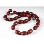 A BEAD NECKLACE, comprising 27 oval beads, approx. 15mm wide and smaller,