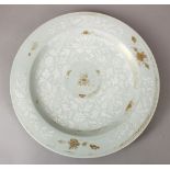 A 19TH CENTURY CHINESE PORCELAIN CELADON GLAZED CHARGER, the body of the charger with white and