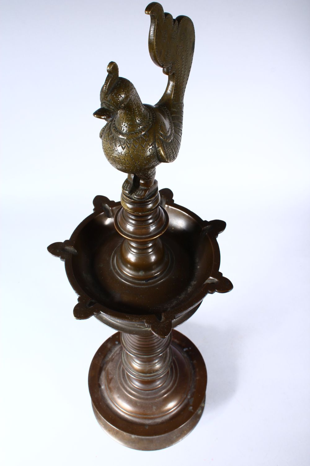 A GOOD 19TH CENTURY INDIAN BRONZE LAMP, with cockerel finial on a circular base, 60cm high. - Image 4 of 4