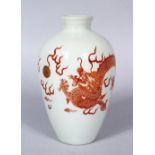 A 20TH CENTURY CHINESE IRON RED PORCELAIN DRAGON VASE, the body with a five claw dragon chasing