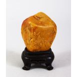 A GOOD CHINESE CARVED SOAPSTONE FIGURE & HARDWOOD STAND, the carving depicting scenes of immortals