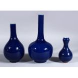 THREE 19TH / 20TH CENTURY CHINESE POWDER BLUE PORCELAIN BOTTLE VASES, 22cm high, 18.5cm & 12cm