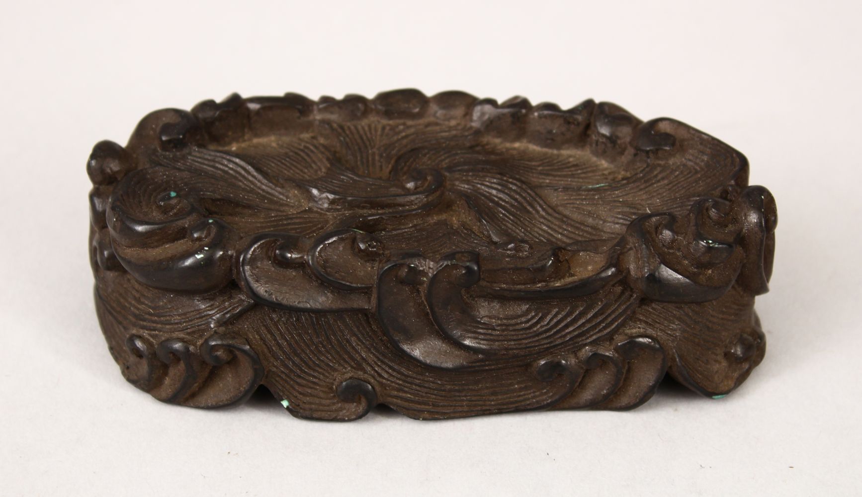 A 19TH CENTURY CHINESE CARVED HARDWOOD WAVE STAND, carved in the form of crashing waves, 12cm wide x