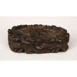 A 19TH CENTURY CHINESE CARVED HARDWOOD WAVE STAND, carved in the form of crashing waves, 12cm wide x