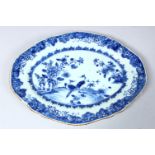 A 19TH CENTURY CHINESE BLUE & WHITE PORCELAIN SERVING DISH, decorated with peacocks amongst native