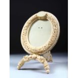 AN 19TH CENTURY SOUTH INDIAN OR SRI LANKAN IVORY PHOTOGRAPH FRAME, the oval frame carved with lions,