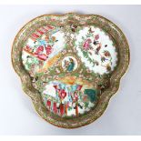 A 19TH CENTURY CHINESE CANTON FAMILLE ROSE PORCELAIN MOULDED DISH, the body of the dish decorated