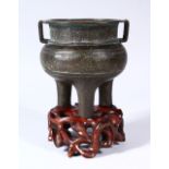 A CHINESE MING DYNASTY BRONZE TRIPOD CENSER, with a band of archaic style decoration and twin