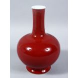 A 19TH / 20TH CENTURY CHINESE RED GLAZED PORCELAIN BOTTLE VASE, the base bearing a six character