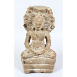 A 18TH/19TH CENTURY CARVED STONE GANDHARA, in a seated position, (af), 32cm high.