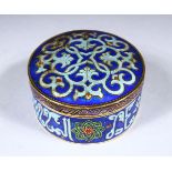 A SMALL ENAMEL DECORATED CIRCULAR BOX AND COVER, 8cm diameter.