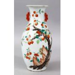 A 19TH CENTURY CHINESE FAMILLE ROSE PORCELAIN TWIN HANDLE VASE, the body of the vase decorated