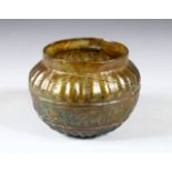 AN EARLY ISLAMIC MOULDED GLASS BOWL, decorated with a band of calligraphy, 11cm diameter.