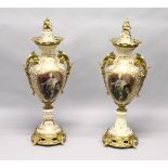 A PAIR OF FRENCH DESIGN PORCELAIN AND ORMOLU PEDESTAL VASES AND COVERS, decorated to one side with a