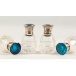 A SET OF FOUR SMALL CUT GLASS SCENT BOTTLES with silver tops, applied with butterfly's wing. 2ins
