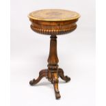 A VICTORIAN FIGURED WALNUT OVAL TEAPOY, fitted with two caddies, supported on a turned and fluted