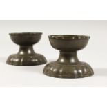 A PAIR OF 17TH-18TH CENTURY PEWTER CIRCULAR PEDESTAL SALTS with touch marks. 3ins diameter.