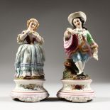 A PAIR OF CONTINENTAL FIGURES OF A GALLANT AND LADY, the girl with a dove. 8ins high.