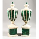 A GOOD PAIR OF LATE 19TH CENTURY WHITE MARBLE AND MALACHITE URNS, on square plinth bases. 15ins
