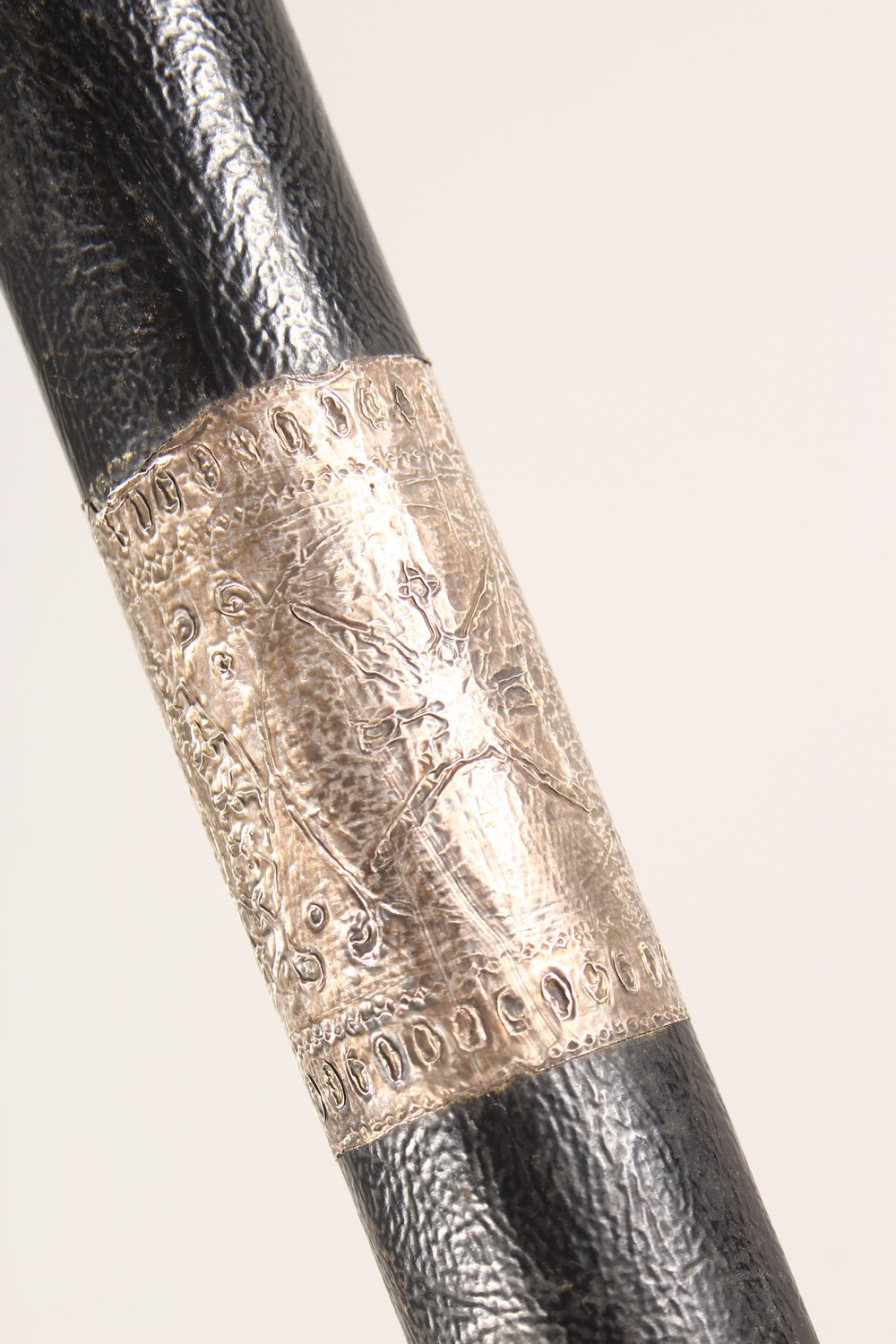 A BLACK LEATHER COVERED WALKING STICK, with eastern white metal mounts. 36ins long. - Image 9 of 11