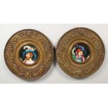 A PAIR OF EMBOSSED CIRCULAR BRASS PLAQUES, inset with porcelain panel decorated with portrait busts.