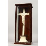 A 19TH CENTURY ITALIAN CARVED IVORY CRUCIFIX. 11ins high in a wooden and glass case.