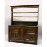 A 19TH CENTURY OAK DRESSER, with a triple Delft rack, the base with a pair of panelled doors on