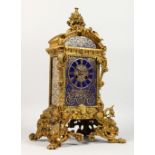 A GOOD 19TH CENTURY FRENCH BRASS CLOCK with masks, urns and scrolls, with blue porcelain face and