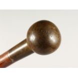 A CANE WITH BAKELITE-STYLE BALL HANDLE. 2ft 10ins long.