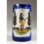 A 19TH CENTURY FRENCH TANKARD, POSSIBLY QUIMPER, a farmer smoking a pipe. 7ins high.