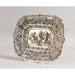 A CONTINENTAL DISH, with pierced decoration, cupids, flowers and garlands. 9.5ins long.