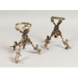 A GOOD PAIR OF CAST, PLATED STANDS, modelled as foxes climbing up grapevines. 5.5ins high.
