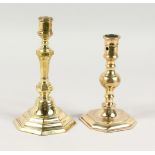 TWO 18TH CENTURY BRASS CANDLESTICKS, on octagonal bases. 7ins and 8ins high.