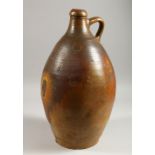 A LARGE BELLARMINE STYLE STONEWARE JUG. 17ins high.