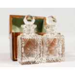 A SMALL LEATHER DOME TOP CASKET containing a pair of cut glass scent bottles. 4.75ins wide.
